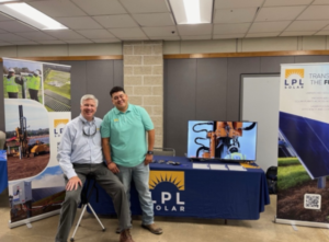 Two men at a table for LPL Solar at hiring event